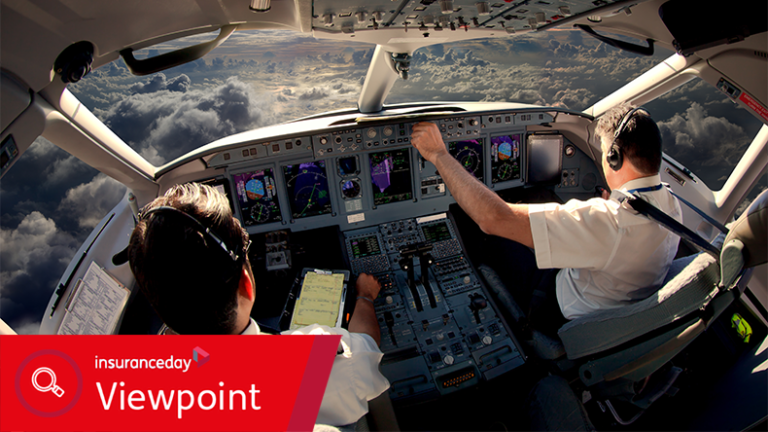 Flight deck of modern passenger jet aircraft. Pilots at work. Cloudy sky and sunset view from the airplane cockpit