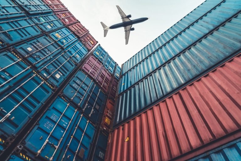 Supply chain operations - aircraft flying over shipping containers
