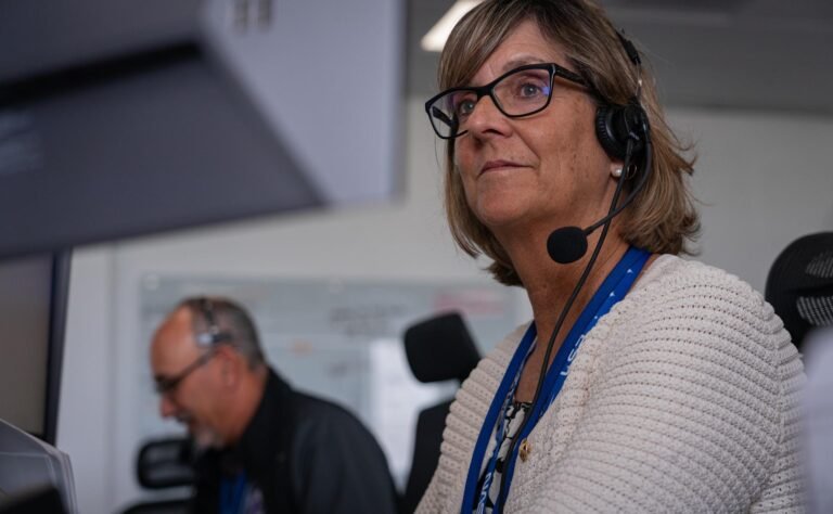 Image shows Jenny Lyon, acting program manager for NASA's Launch Services Program based at NASA Kennedy wearing a headset and a white knitted top. Photo credit: SpaceX