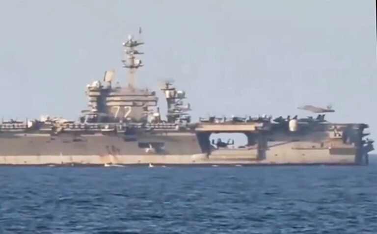 Sailors take footage of USS Abraham Lincoln during flight ops in the Arabian Sea