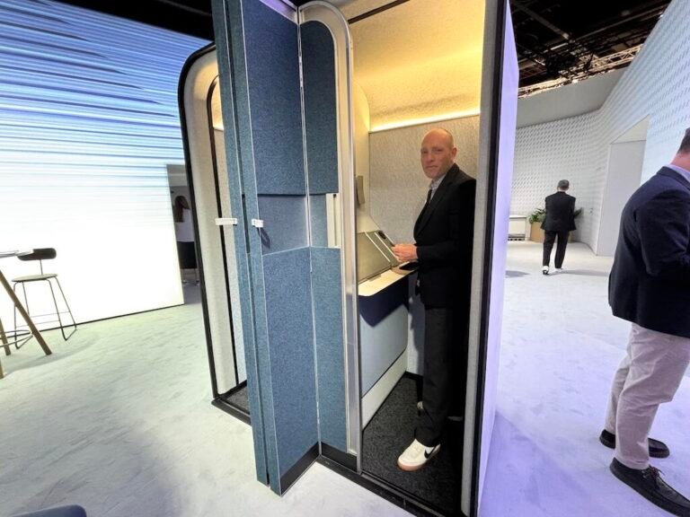 A demonstration model of a Boeing pod for airliners, in which a man is standing at an enclosed workspace.