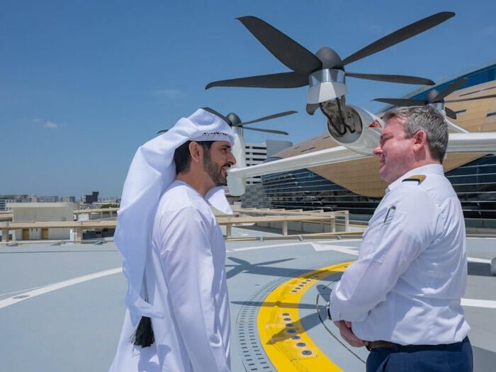 Men talking next to VTOL aircraft