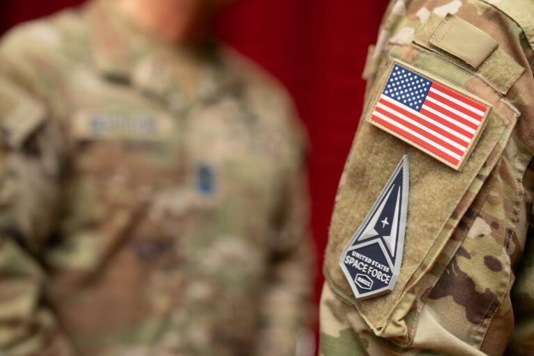 A new U.S. Space Force patch sits on the uniform of Specialist Conner Portman, a graduating Guardian, during a Basic Military Training patching ceremony at Bob Hope Theater, Joint Base San Antonio-Lackland, Texas, Feb. 17, 2026.  Credit: U.S. Air Force photo by Jonathan R. Mallard