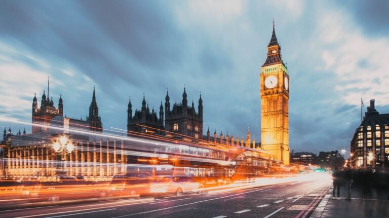 Applications open for self-driving taxi and bus operators in the UK Blurred lights of vehicles crossing Westminster Bridge in London with the Houses of Parliament in the background.