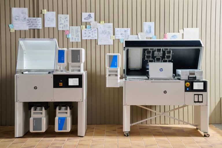 The HP Multi Jet Fusion 1200 3D Printer Solution, showing the processing station (left) and print unit (right). Photo via HP.