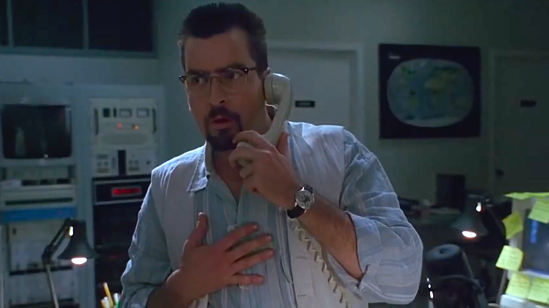 ‘The Arrival’ at 30: Charlie Sheen’s criminally underrated alien invasion thriller feels much scarier today a worried man on a telephone