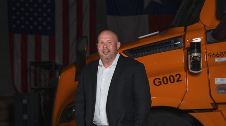 Bot Auto strengthens leadership team to scale autonomous trucking Brett Suma wears a dark suit and a white shirt, no tie. He is standing in front of an orange truck.