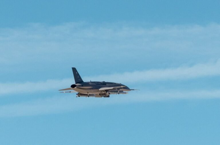 Pictured is a U.S. Air Force photo of an Anduril Industries YFQ-44A flying over Edwards AFB, Calif. during a test by Air Combat Command