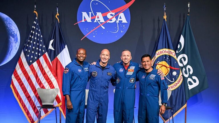 NASA Looks Ahead To Artemis III Andre Douglas, Luca Parmitano, Randy Bresnik and Frank Rubio pose in front of flags