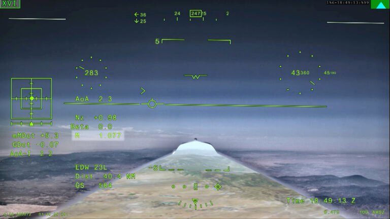 NASA’s X-59 Aircraft Flies Supersonic for First Time NASA’s X 59 eXternal Vision System digital display shows green flight data overlaid on the forward scenery as the aircraft flies supersonic. Numerical indicators, horizon references, and a Mach number readout are visible on the screen.