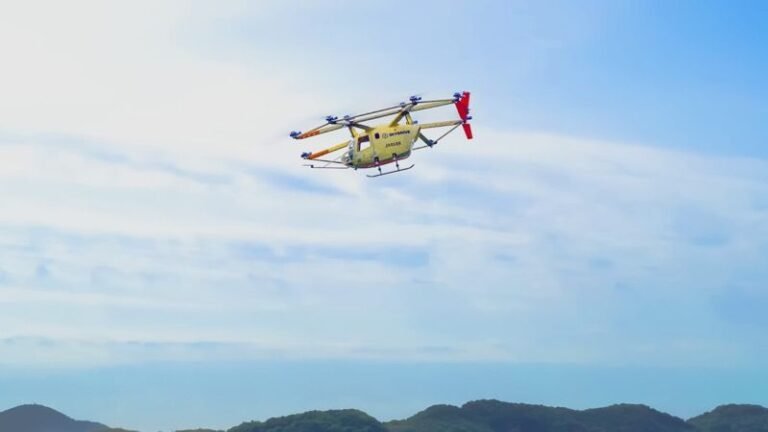 SkyDrive SD-05 multicopter eVTOL aircraft in forward flight against a blue sky above hills