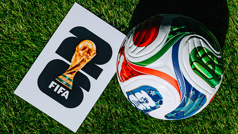 Official FIFA World Cup 2026 Match ball on pitch and official logo of football tournament in USA, Canada and Mexico