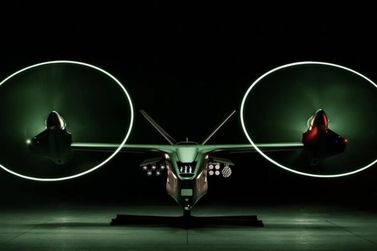 Front view of the Thunder autonomous tiltrotor in a darkened hangar, its two rotor discs shown as glowing green circles, with sensor and weapons pods mounted on the nose
