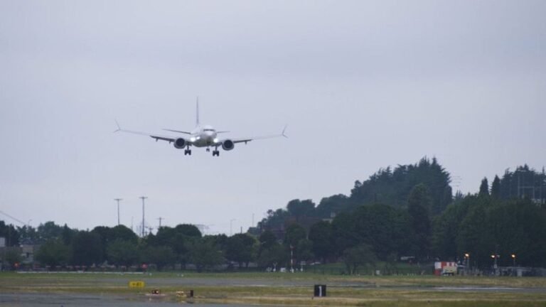 Boeing completes certification flight testing for the 737-10 A Boeing 737-10 test aircraft on final approach to land at Boeing Field on an overcast day, with landing gear extended over the airfield perimeter
