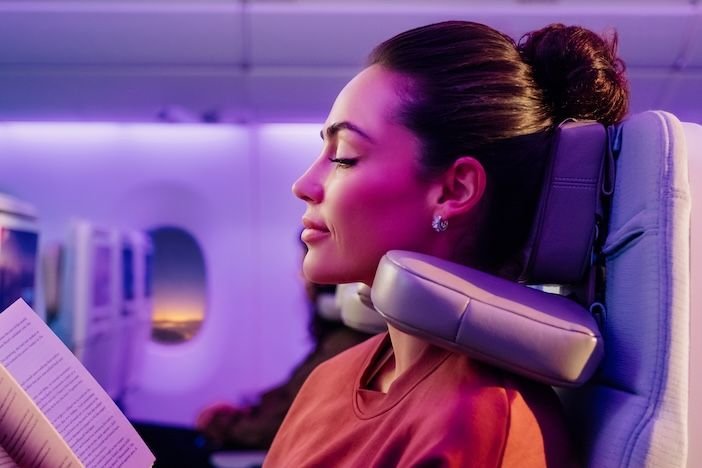 Emirates is installing 8-way headrests in economy class A female passenger resting comfortably with the Emirates U-Dream headrest adjusted around her neck
