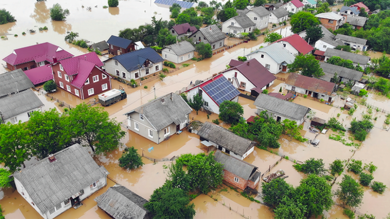 Flood Re unveils insurance incentive to boost resilience Flooded residential neighbourhood