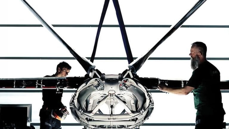 From Factory Floor To Earth Orbit, Aerospace Faces Pivot Points two people standing by 3D-printed aircraft fuselage