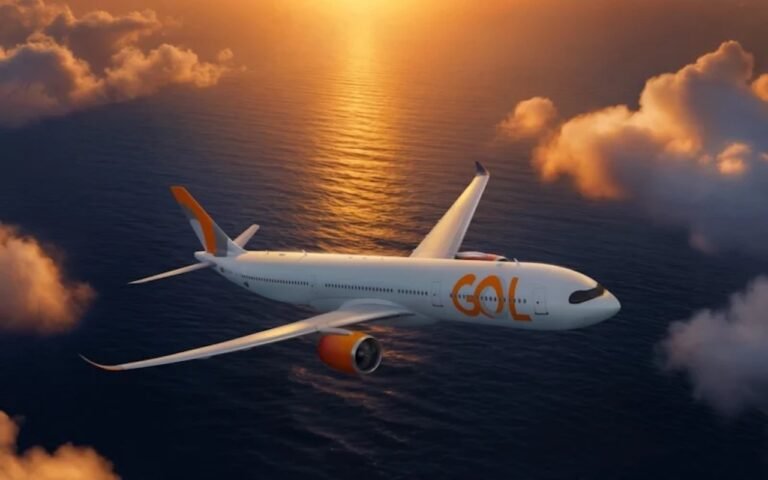 GOL completes first long-haul A330 flight to New York JFK GOL Airlines airliner with orange accents flying over the ocean at sunset viewed from the side in warm light