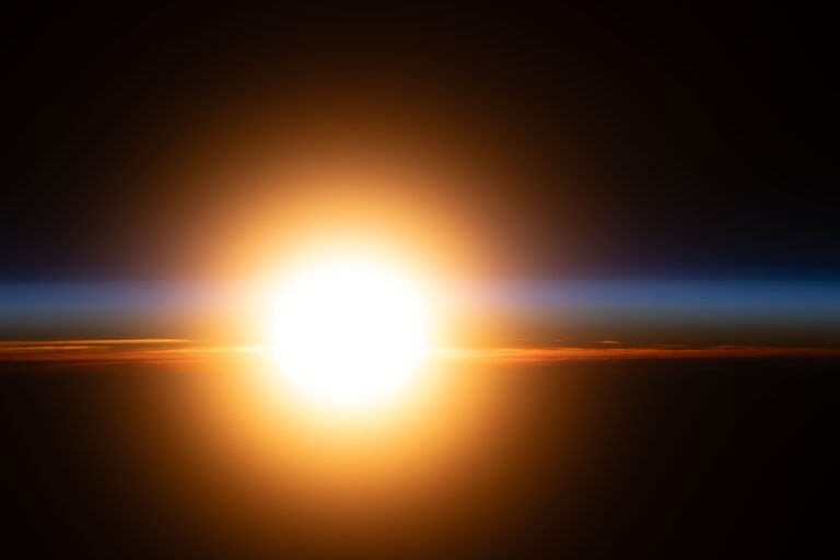 Good Morning, Earth! – NASA A bright orange sunburst illuminates Earth's atmosphere during an orbital sunrise.