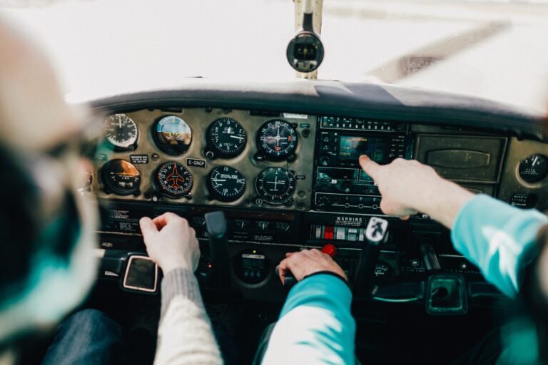 Flight instructor and student operate inside a small Piper aircraft. [Credit: Adobe Stock]