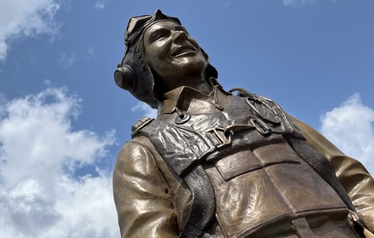 There’s a new statue in the warbirds section at Oshkosh that honors C.E. ‘Bud’ Anderson, a onetime fan favorite at EAA AirVenture. [Credit: Meg Godlewski]