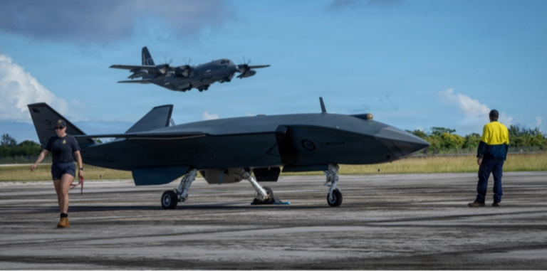 PACAF Evaluating Boeing MQ-28 Ghost Bat In Valiant Shield Pictured is a U.S. Air Force photo of an HC-130J Combat King II with the 79th Rescue Squadron taking off behind an MQ-28 Ghost Bat, a production representative test aircraft by Boeing Defence Australia, during Exercise Valiant Shield 2026 at Rota, Commonwealth of the Northern Mariana Islands, on June 21.
