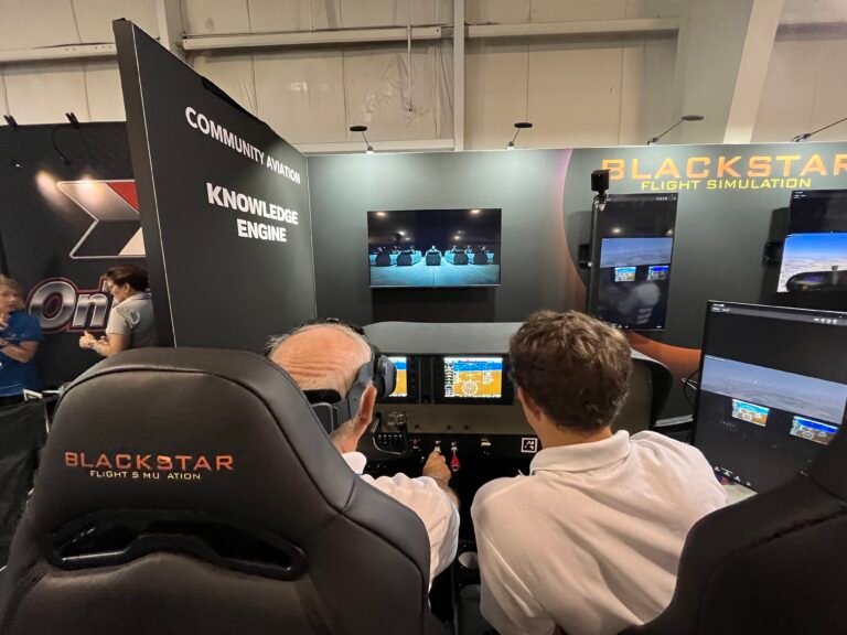 Attendees try out the Blackstar Eclipse Advanced Aviation Training Device at AirVenture. [Credit: Meg Godlewski]