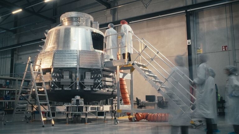 Space startup The Exploration Company uses Siemens Xcelerator to develop reusable spacecraft Engineers in cleanroom suits working on a metallic spacecraft capsule mounted on a test stand in a manufacturing facility