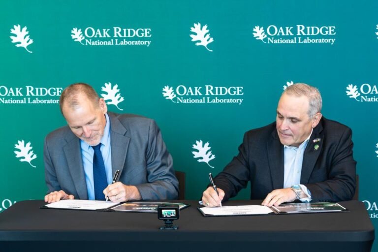 Robert Wagner, ORNL associate laboratory director, left, and Anthony Nickens, INL division director, announce a partnership between ORNL and INL during M2IND. Photo via Carlos Jones/ORNL, U.S. Dept. of Energy
