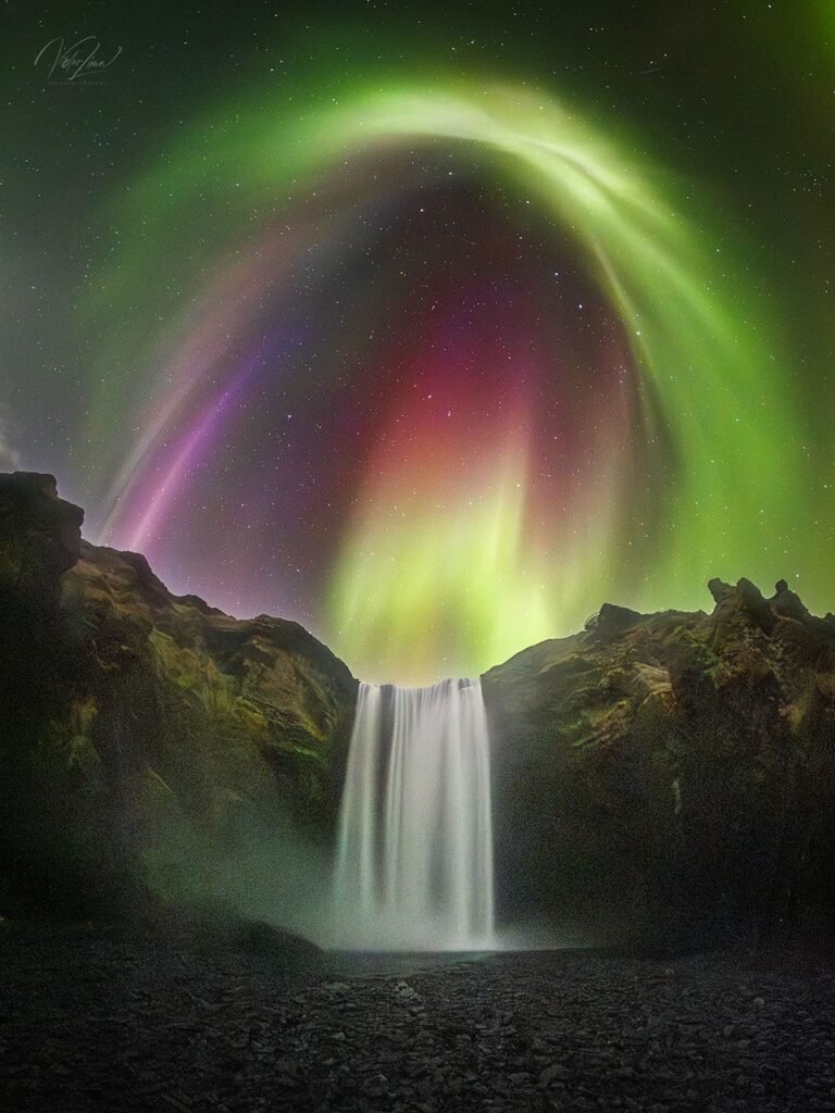 APOD: 2026 August 27 - Colorful Aurora over an Icelandic Waterfall