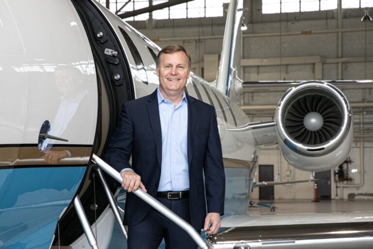 Departing FAA Leader Says Agency Is Being ‘Nudged’ to Embrace Risk Chris Rocheleau standing in front of business jet