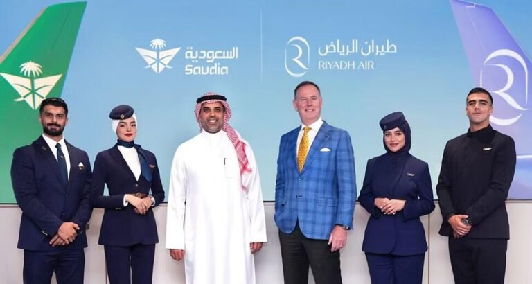 six people standing in front of screen showing Saudia and Riyadh Air logos and aircraft tails