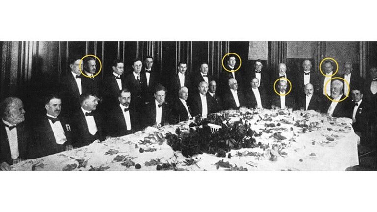 group of men at a dinner table with five heads circled