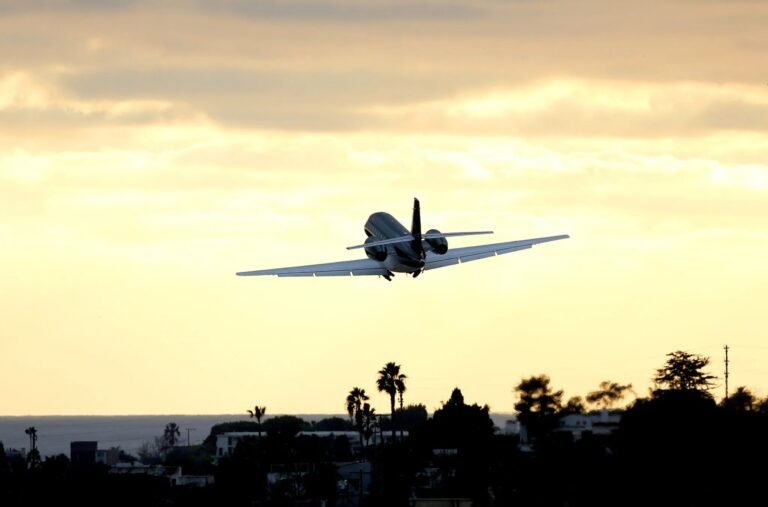 business jet taking off from airport