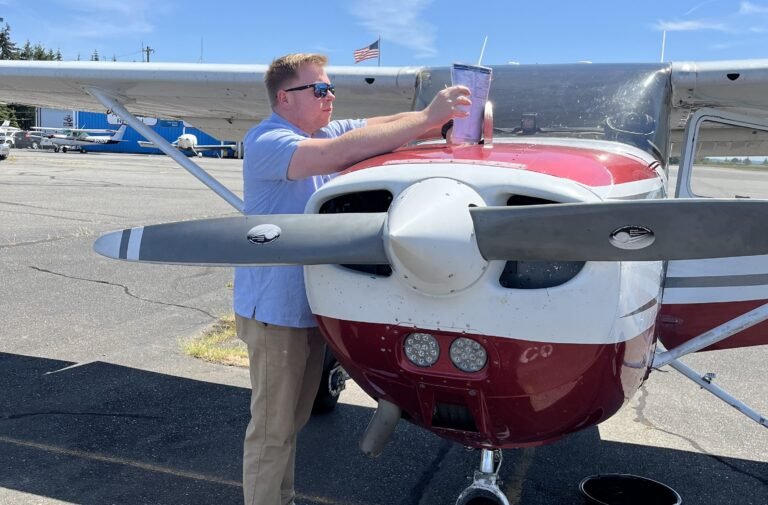Student pilot uses a checklist during preflight process. [Credit: Meg Godlewski]