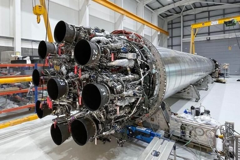 large space rocket engine displayed in an industrial hangar