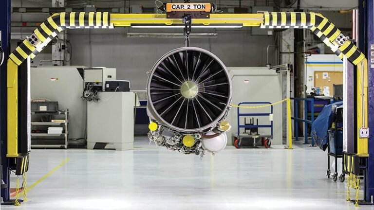 GE Plans To Double Fighter Engine Production By 2032 GE F110 engine hanging in facility
