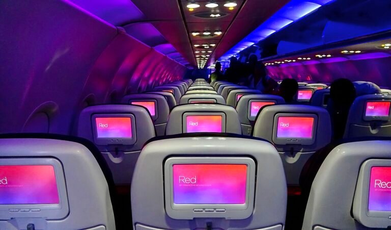 Pilots of AA1779 reported a passenger in seat 9D undressed herself and acted indecently in view of nearby PAX