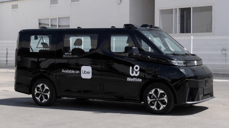 A black WeRide, Uber and AVOMO autonomous passenger vehicle parked on a quiet urban street in Madrid, Spain.