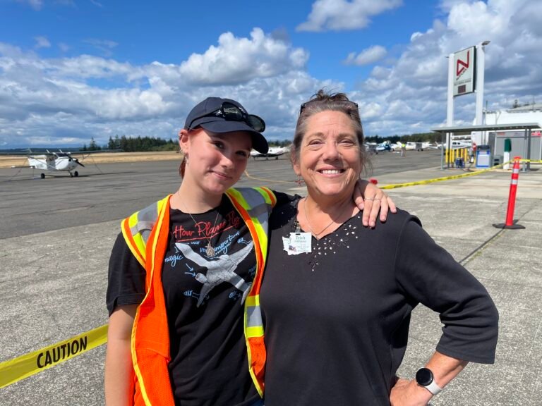 Trish WIlliams (right) poses with Violet Weir, a senior in high school who has been building airplanes with EAA Chapter 406 for several years. Weire has earned several scholarships and is pursuing her pilot certificate. [Credit: Meg Godlewski]