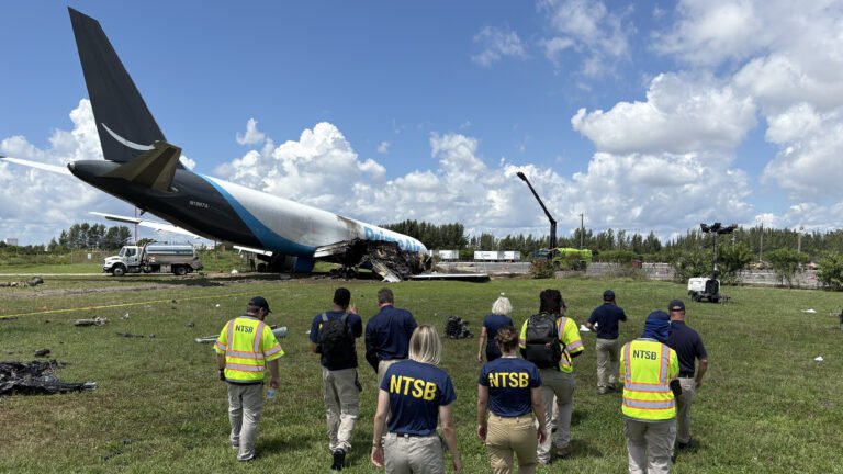 NTSB personnel approach Amazon Prime Air 21 Air Boeing 767-33A cargo jet wreckage at Miami International Airport