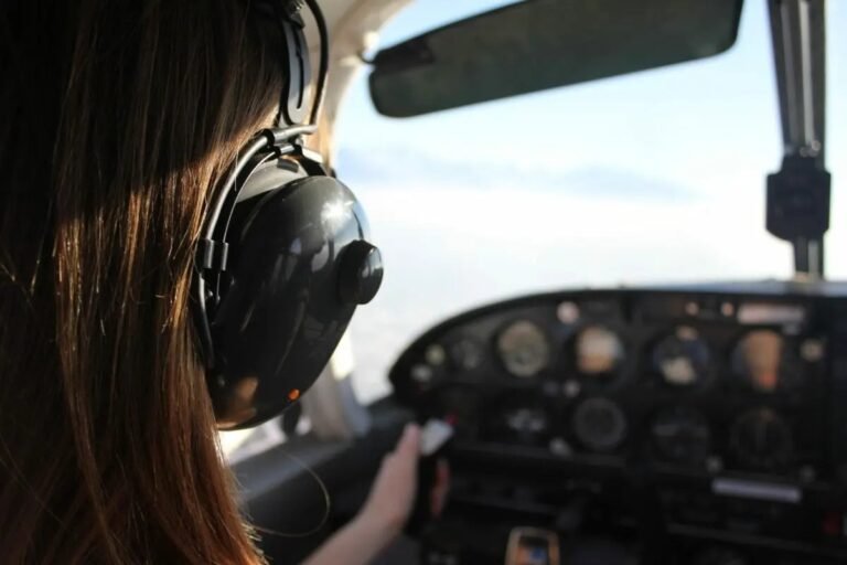 Pilot wearing headset and looking out cockpit window