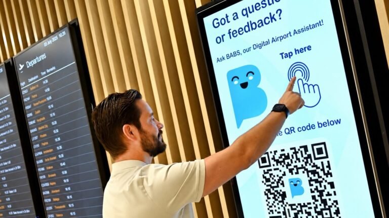 Birmingham Airport’s AI assistant BABS answers thousands of passenger inquiries in first year A passenger engages with Birmingham Airport's AI assistant BABS using its touch screen.