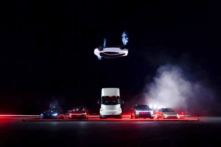 Breaking Down Tesla’s Flying Roadster Debut Tesla flying Roadster inverted over a row of other vehicles