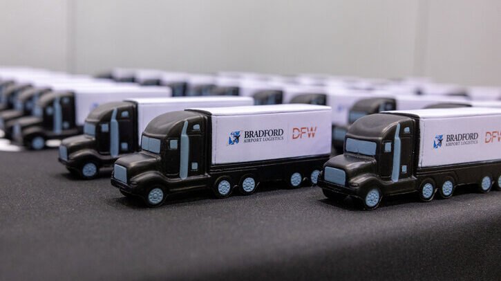 DFW opens logistics facility to support expanded dining, shopping and lounge options A row of toy Bradford Airport Logistics trucks.