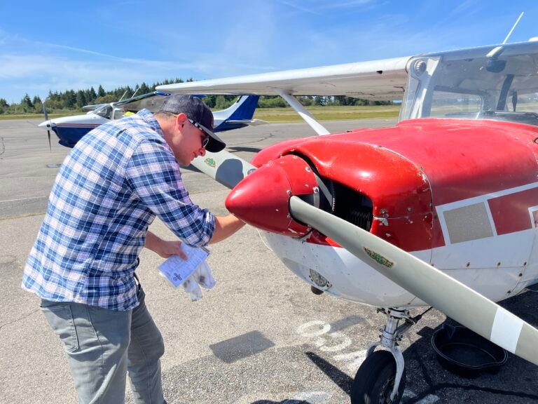 Student pilot examines the prop during preflight check. [Credit: Meg Godlewski]
