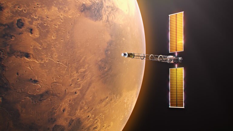Digital illustration of the Space Reactor-1 (SR-1) Freedom spacecraft in orbit near Mars. The planet's red terrain fills the left half of the frame. On the right, the spacecraft is oriented horizontally, showcasing its central Power and Propulsion Element bus flanked by two tall, illuminated golden Roll-Out Solar Arrays. An elongated open-truss boom extends forward from the bus, ending at the cylindrical nuclear fission reactor and power conversion module.