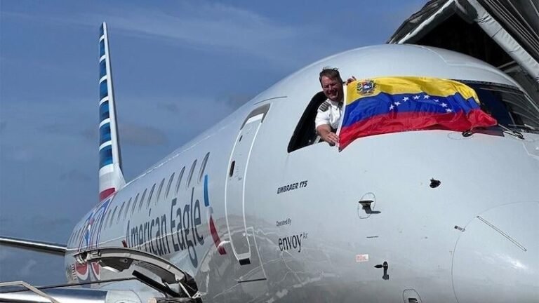 Routes & Networks Latest: Rolling Daily Updates (W/C Oct. 19, 2026) pilot with Venezuelan flag leaning out of american airlines aircraft cockpit window