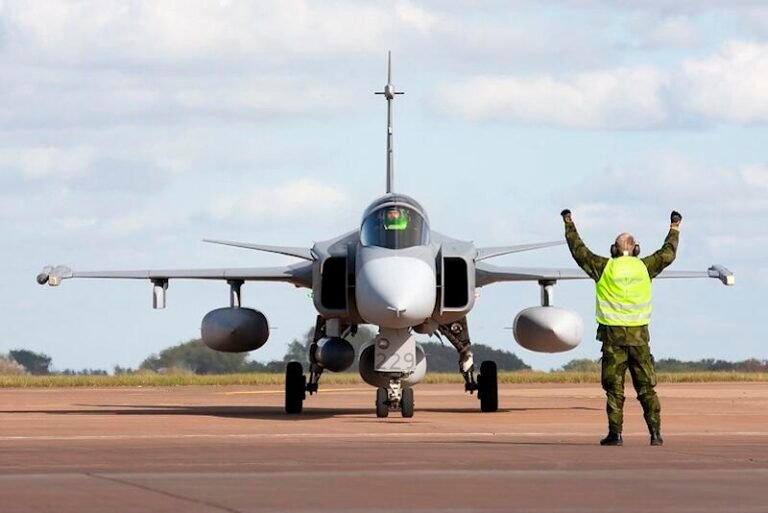 Saab To Develop New Gripen Flight Computer ground crew member in vest guides jas 39 gripen fighter jet
