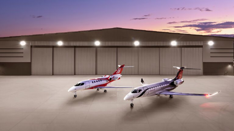 SyberJet SJ34 and SJ36 business jets in front of hangar